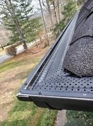 Smart Flow perforated aluminum gutter guard installed on roof
