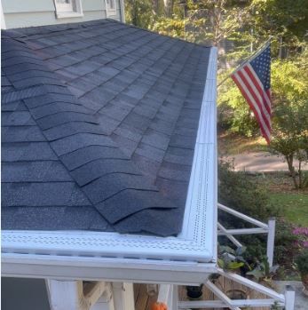 White Leaf Free gutter topper installed on home with American flag in background